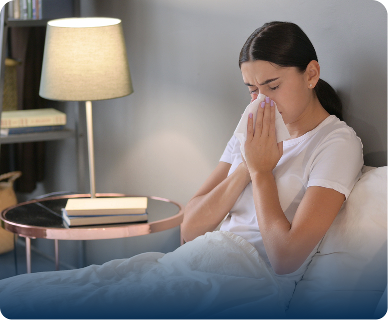 Woman suffering from cold in bed