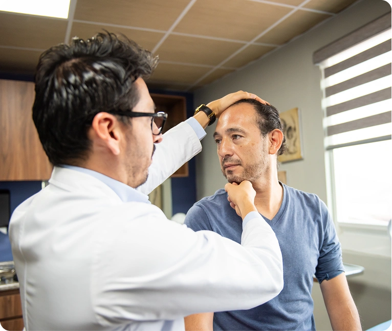Man getting his hair cut by a doctor wearing glasses and a watch