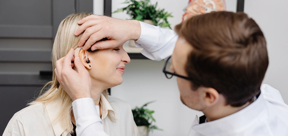 Woman getting her ear examined by a doctor