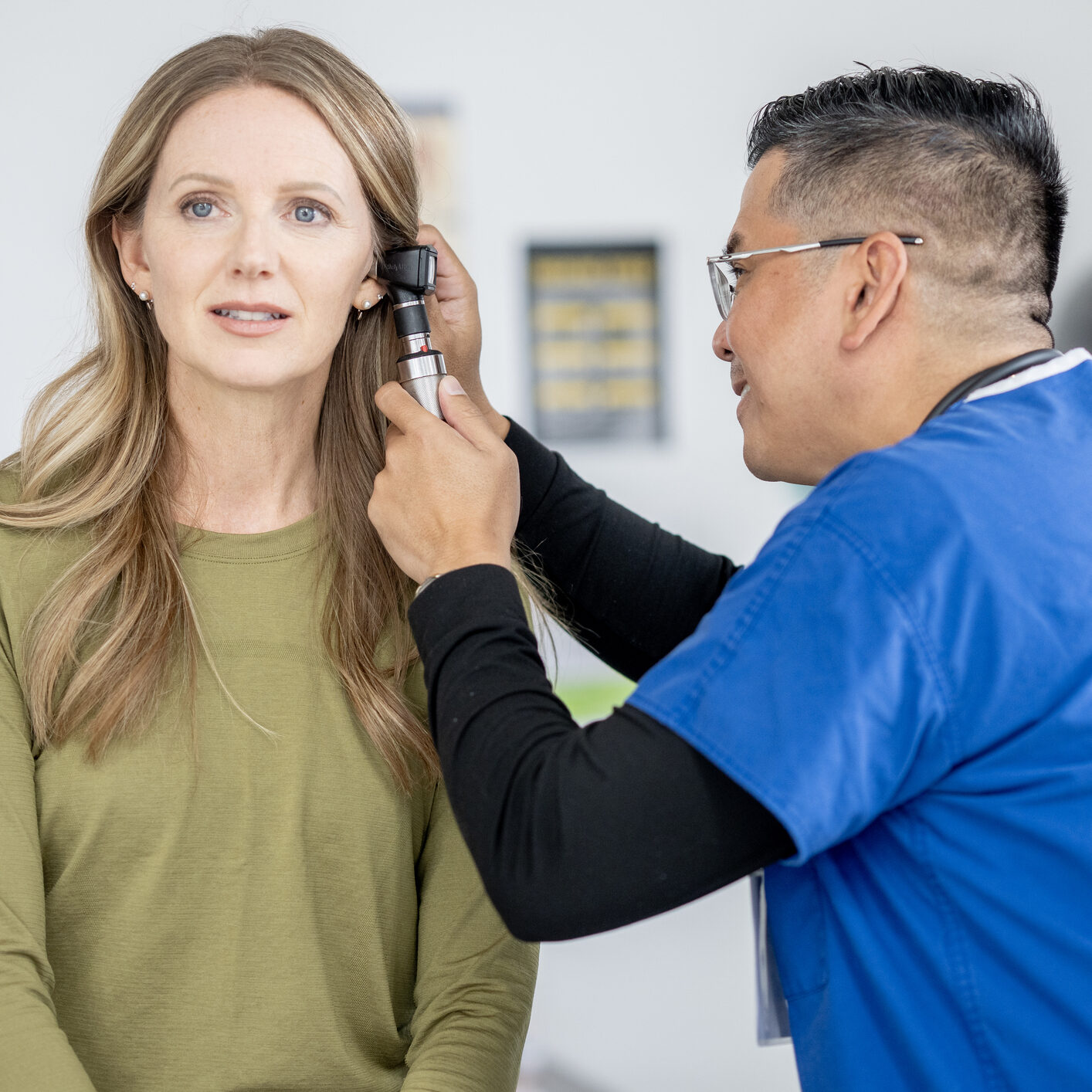 Woman in a shirt being examined by a doctor wearing a dress