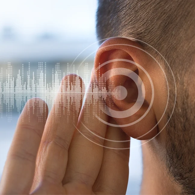 Man with his hand on his ear, touching a sound waveform, indicating that he is listening to a podcast