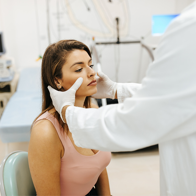 Dermatologist examining patient's skin
