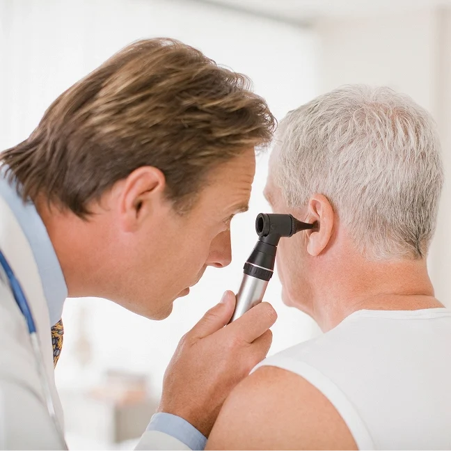 Physician checking patient's hearing